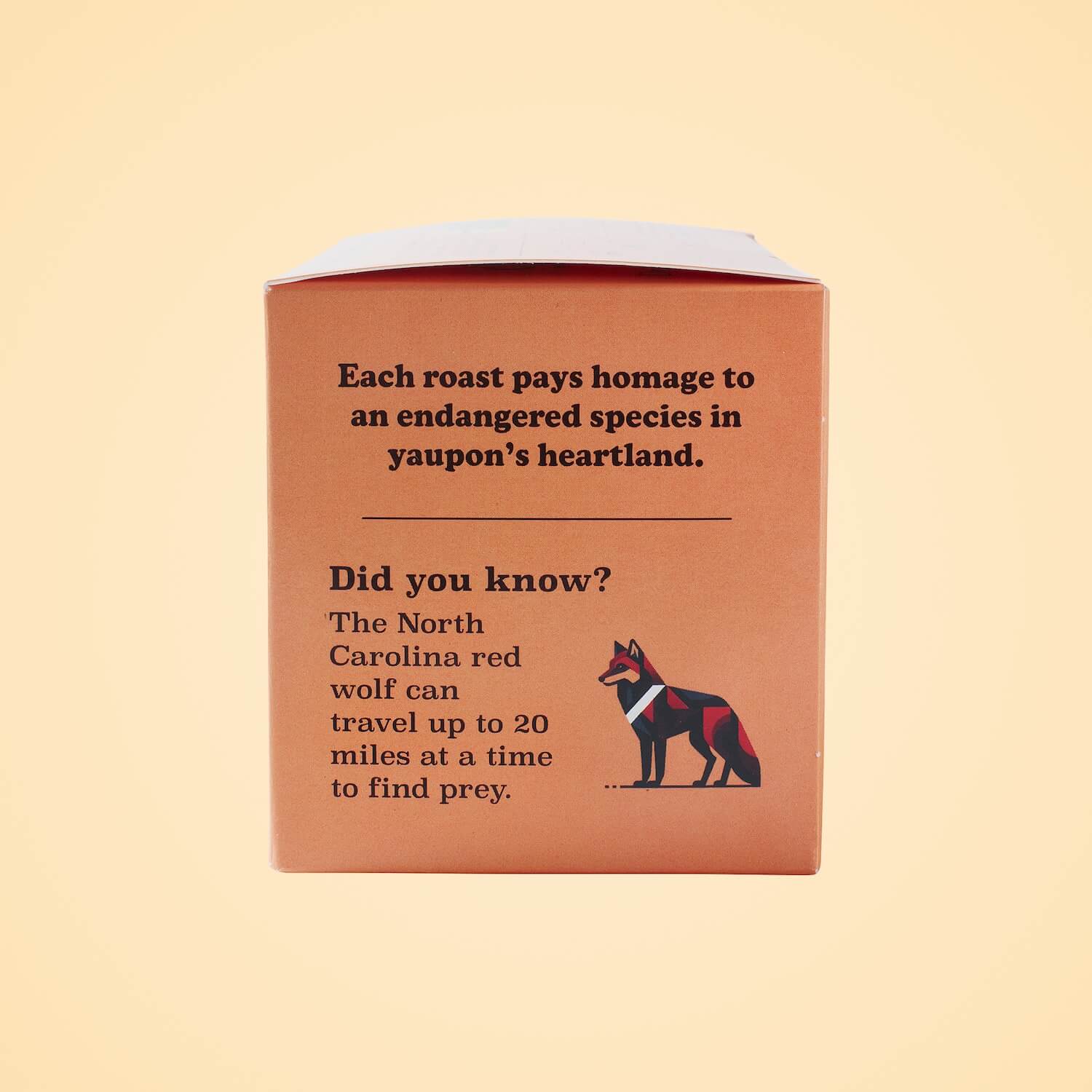 Goldholly Red Wolf Dark Roast box side panel highlighting North Carolina red wolf conservation with geometric wolf illustration and educational facts about endangered species protection through sustainable business.