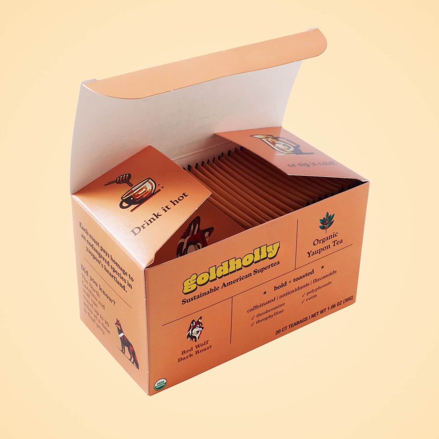 Opened Goldholly Red Wolf Dark Roast box revealing carefully arranged teabag packets with interior messaging, demonstrating premium packaging design for bold, toasted yaupon tea experience.