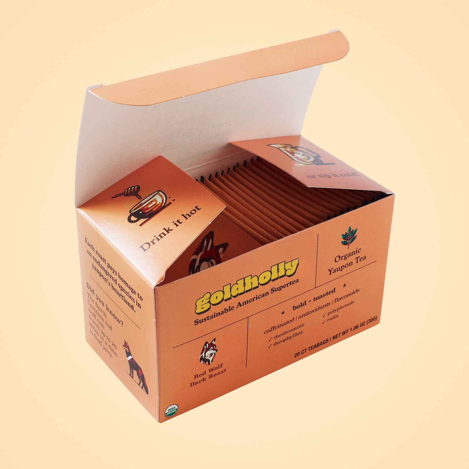Opened Goldholly Red Wolf Dark Roast box revealing carefully arranged teabag packets with interior messaging, demonstrating premium packaging design for bold, toasted yaupon tea experience.