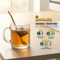 Clear glass mug of steeping yaupon tea with a teabag visible, beside the Goldholly Energy Your Way dosing guide showing 1 bag for Improved Focus, 2 bags for All-Day Energy, 3 bags for Peak Performance--4