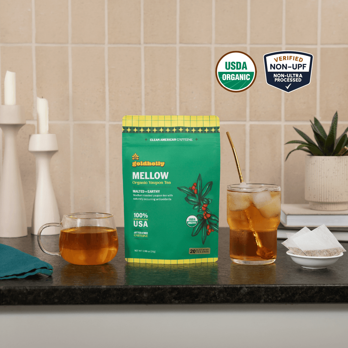 Goldholly Mellow organic yaupon tea pouch on a kitchen counter with a mug of hot tea and a glass of iced tea; USDA Organic, Verified Non-UPF--1