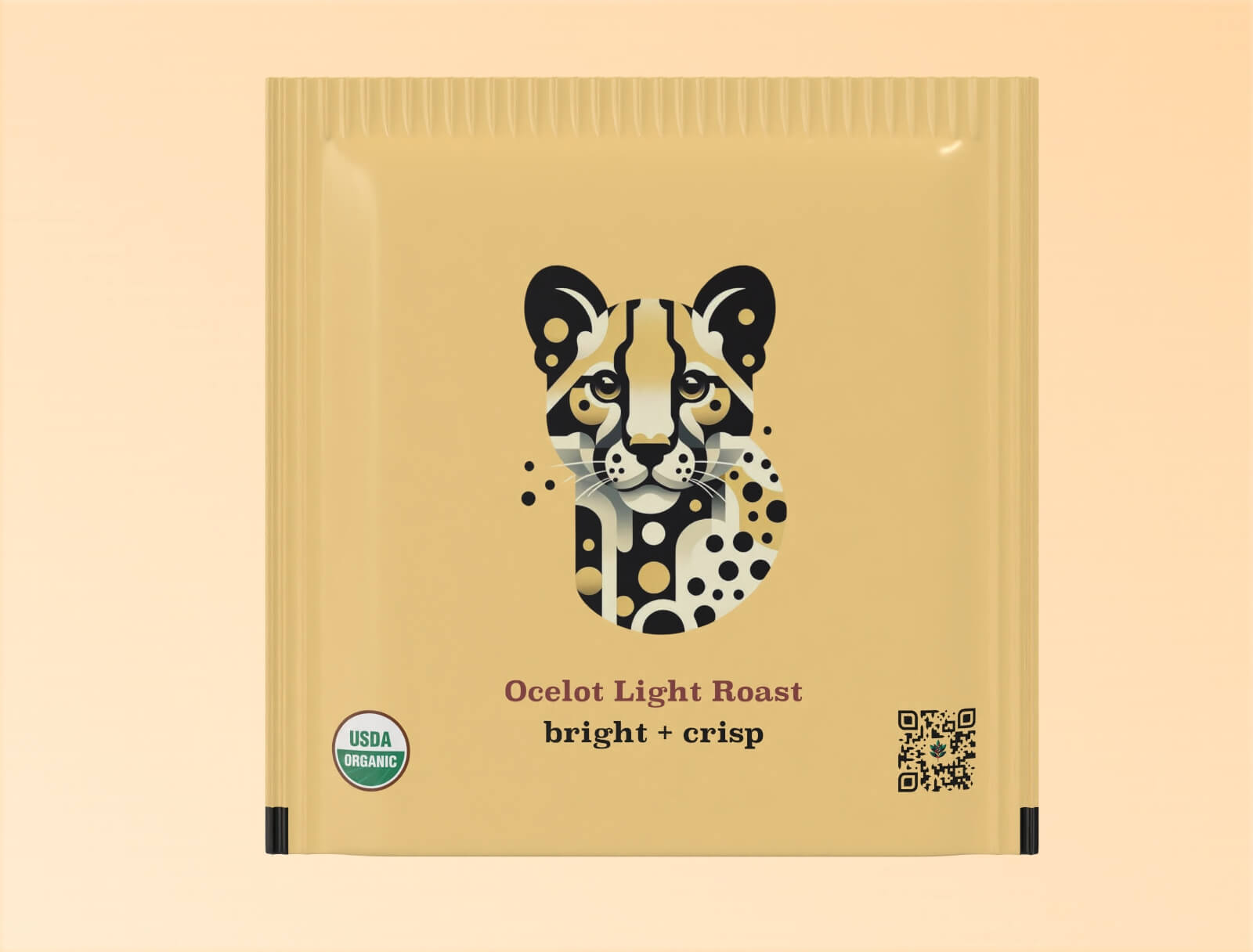Individual teabag packaging for Goldholly's Ocelot Light Roast yaupon tea. The light yellow sachet features a geometric, color-blocked illustration of an ocelot face with distinctive spotted pattern in black, white, and gold. Below the illustration are the words 'Ocelot Light Roast' and 'bright + crisp' in dark typography. The package includes a USDA Organic certification seal and QR code.