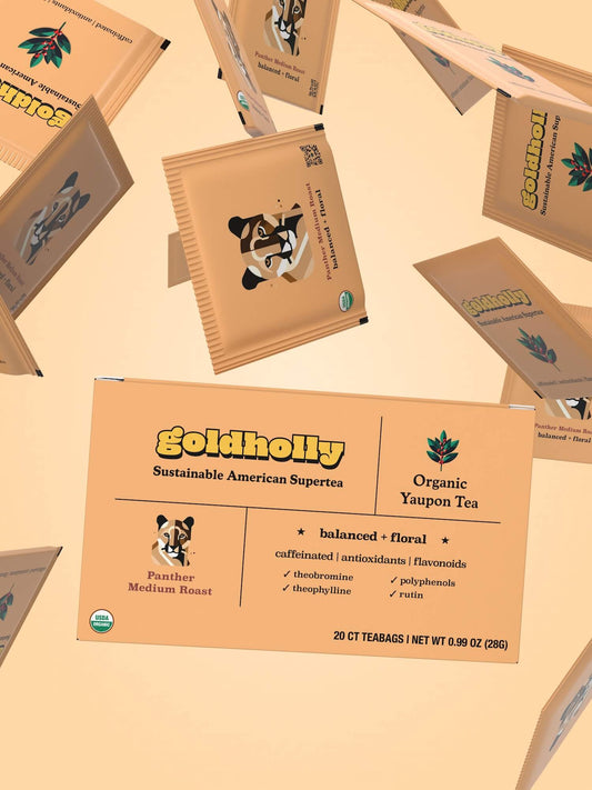 Goldholly Organic Yaupon Tea packaging for the Panther Medium Roast blend, featuring a balanced and floral flavor profile with caffeine, antioxidants, and flavonoids like theobromine and theophylline. The box highlights yaupon holly's clean American energy and sustainable, regenerative farming practices, set against a yellow background.