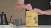 Goldholly yaupon tea brewed hot and over ice in home kitchens, shown with the Original, Bold, and Mellow pouches, the yaupon holly plant, and the wild landscape of the American South where yaupon natively grows.